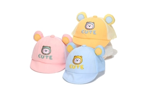 Detail view of mesh baby caps with cute bear ears and embroidery in soft pastel colors