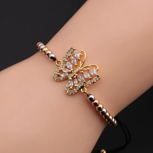 Close-up of zircon butterfly bracelet with adjustable black cord on wrist