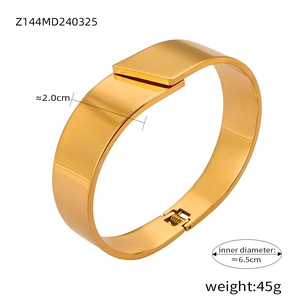 Detail view of 2cm wide polished gold titanium steel bangle showing size measurements