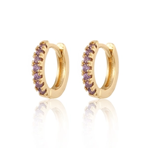 Close-up of gold plated hoop earrings with inlaid purple zircon stones on white background