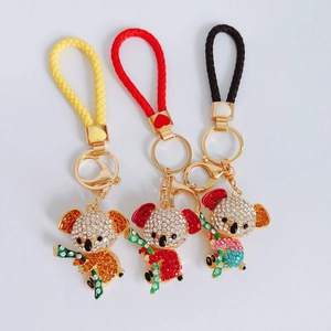 Detailed view of three koala keychains with rhinestones and colorful braided ropes