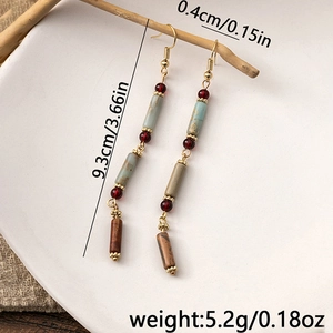 Detail showing vintage beaded earrings dimensions 9.3cm length on rustic wood background