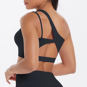 Detail view of black one-shoulder sports bra with unique strappy open-back cutout design