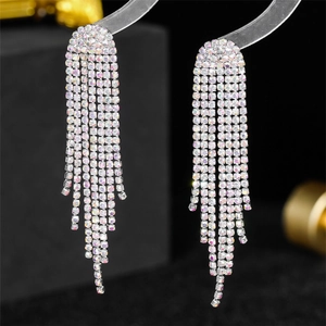 Detail view of long luxury tassel earrings with holographic rhinestones on silver chains