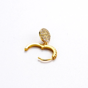 Golden huggie hoop earring with star-patterned sparkling zircon pendants on white background