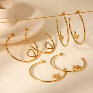 Close-up of gold stainless steel hoop earrings with cutout heart, star, and butterfly charms