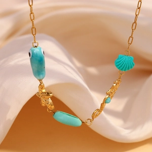 18K gold plated ocean necklace with blue fish, starfish and shell charms on silk