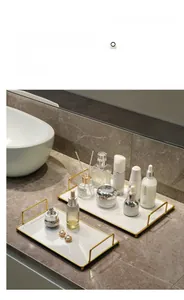 Detailed macro view of golden metal frame trays with elegant white marble texture bases
