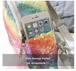 Detail of the side pocket on a rainbow sequin backpack showing phone storage and pink pompom