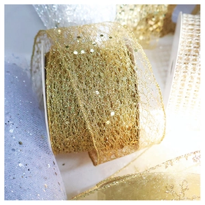 Detailed macro view of sparkling glitter mesh ribbon with hexagonal sequins for gift wrapping