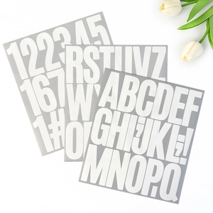 Three sheets of 3-inch white waterproof letter and number stickers in a fan arrangement