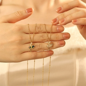 Close-up of ballet dancer pendant with colorful zircons on a delicate gold chain