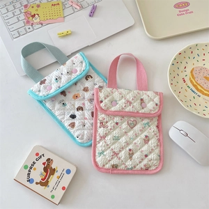 Flat lay of quilted cotton storage bags with cute puppy patterns and soft handles