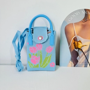Blue knitted phone bag with pink tulip pattern and round handle for crossbody use