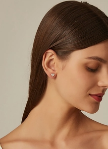 Detail of 14K gold-plated S925 silver heart stud earrings with sparkling cubic zirconia