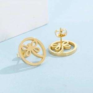 Detailed side view of gold dragonfly hollow stud earrings on a blue background