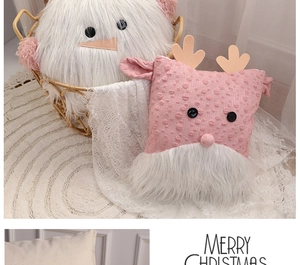 Close-up of white plush and pink knitted Santa pillows with Merry Christmas text