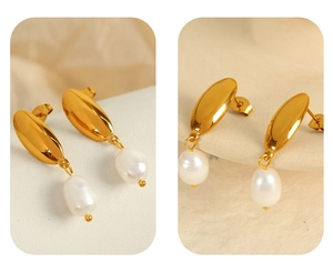Close-up of 18K gold crescent hoop earrings with hanging white freshwater pearl drops