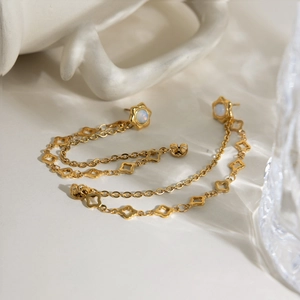 Dettaglio orecchini oro 18K con fiori di opale, quadrifogli e lunghe catene a nappa