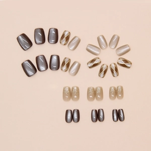 Detailed view of checkerboard pattern and cat eye press-on nails in brown and grey