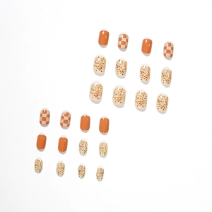 Glossy orange checkerboard press-on nails with abstract artistic autumn patterns