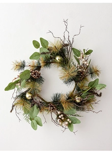 Detail of Christmas wreath with pine needles, cones, golden balls and white berries