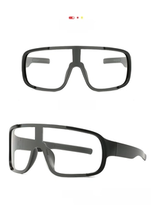 Front and side views of matte black cycling goggles with clear lenses and wide nose pads