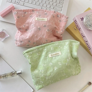 Detail of floral texture cosmetic bags with Sozakka tags in pink and green
