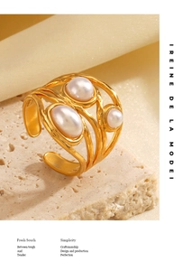 Macro detail of 18K gold-plated wide ring with hammered texture and three inset pearls