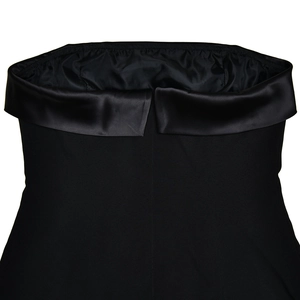 Detail of black strapless dress featuring a elegant satin folded neckline design