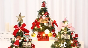 Three mini Christmas trees with LED lights, colorful ornaments and festive bows
