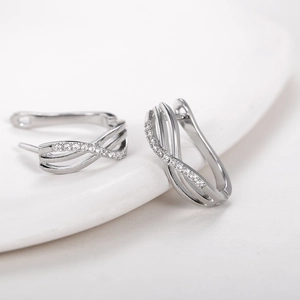 Minimalist geometric twisted silver hoop earrings with sparkling zircon inlay for women