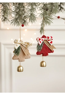 Detail of plush Christmas tree ornaments with golden bells and festive paper tags