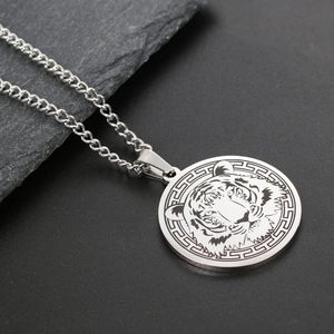 Macro detail of silver stainless steel tiger head pendant with Greek key border pattern