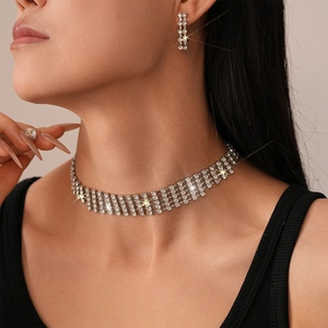 Macro shot of a tiered rhinestone choker necklace and matching dangle earrings