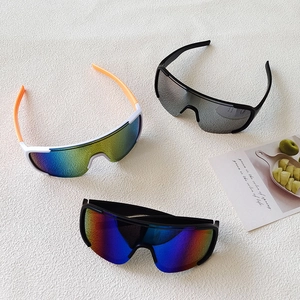 Three pairs of oversized outdoor cycling sunglasses on a white textured background