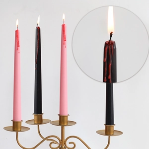 Halloween bleeding long pillar candles in pink and black on golden metal holder