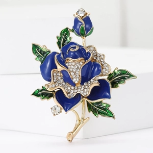 Elegant blue enamel rose brooch with rhinestones and gold stem on a white pedestal