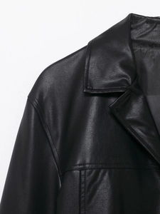 Close-up of high-quality black coated leather texture on collar and shoulder of the jacket