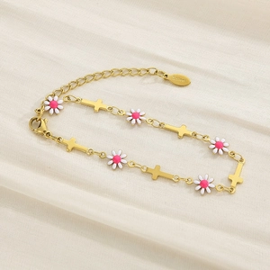 Detail of gold daisy bracelet with pink and white floral charms and a cross pendant