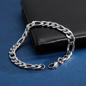 Detail of silver stainless steel flat link chain bracelet with lobster clasp and extension