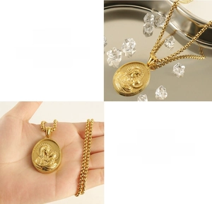 Macro detail of 18k gold plated 3D relief religious pendant with textured chain links