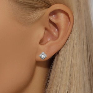 Close-up of s925 silver halo stud earring with clear crystals on woman's ear