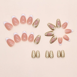 Detail of nude pink press on nails with gold accents and almond shape French tips