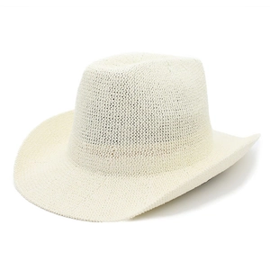 Close-up of a cream woven straw cowboy hat with a classic wide brim and pinched crown