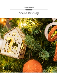 Close-up of lighted wooden Christmas house ornament with reindeer and star cutouts