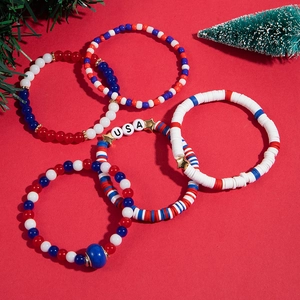 Five-piece Christmas themed beaded bracelets set featuring USA letters and holiday charms