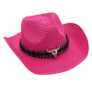 Detail of rose pink straw cowboy hat with ethnic band and silver bull skull ornament