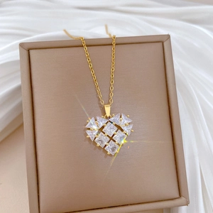 Close-up of heart pendant with sparkling faceted stones on gold stainless steel chain