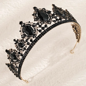 Detailed view of gothic gold crown featuring large black gemstones and dark rhinestones